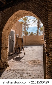 An arch leading to a sunny terrace of the old building, Tunis
