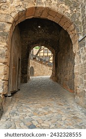 Arch, path and brick wall with tunnel of ancient passageway, building pattern or exterior architecture. Empty route, concrete trail or historic landmark of secret hallway or hidden outdoor corridor