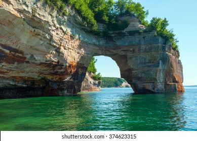 Arch of rock extends from the shoreline directly in Lake Superior, Pictured Rocks National Lakeshore, Michigan