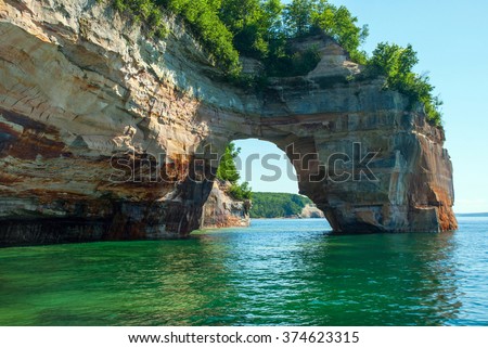 Arch of rock extends from the shoreline directly in Lake Superior, Pictured Rocks National Lakeshore, Michigan