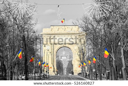The Arch of Triumph (Arcul de Triumf) from Bucharest Romania, National Day with romanian flags, view from Kisseleff Avenue.