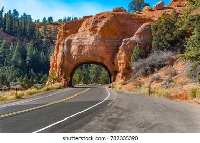 Arch tunnel through rock along scenic highway 12 near Red Canyon. Utah