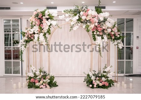 Arch for the wedding ceremony, decorated with white and pink flowers. Wedding day.