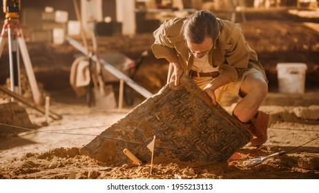 Archaeological Digging Site: Great Male Archeologist Work on Excavation Site, Carefully Cleaning, Lifting Newly Discovered Ancient Civilization Cultural Artifact, Historic Clay Tablet, Fossil Remains - Shutterstock ID 1955213113