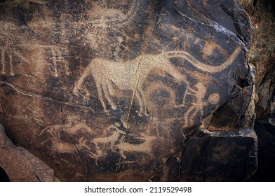 Archaeological petroglyph animals and hunters of Tamgaly (also known as Tanbaly) ancient rock carvings) from second half of the second millennium BC, Kazakhstan. 