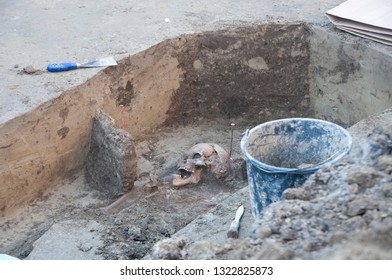 Archaeological Site. Shallow Grave With Skull And Some Tools. 