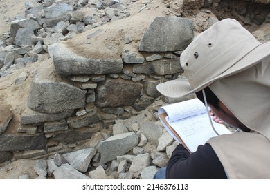 An Archaeologist In His Field Work Drawing In An Excavation At An Archaeological Site