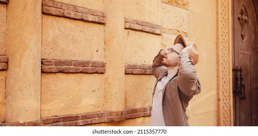 Archaeologist Man In Hat Background Of Ancient Buildings. Concept Banner Tour Guide Archeological Old City.