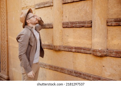 Archaeologist Man In Hat Background Of Ancient Buildings. Concept Tour Guide Archeological Sit Old City.