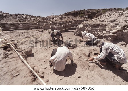 Archaeologist working in field, with special tools