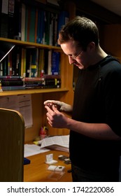 Archaeology Student Analysing Artefacts At A Desk 