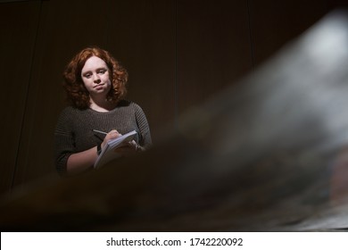 Archaeology Student Takes Notes On A Note Pad 