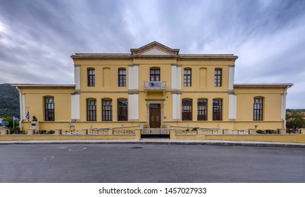 Archanes Town, Crete Island - Greece - March 11, 2019: Panoramic View Of The Facade Of The Old Building That Used To Be The Town Hall Of Archanes Town. Now Houses The Hellenic Open University In Crete