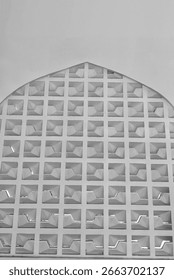 Arched architectural panel featuring a grid of square openings with three-dimensional angular designs—captures geometric repetition, depth, and shadow play, ideal for architectural detail visuals