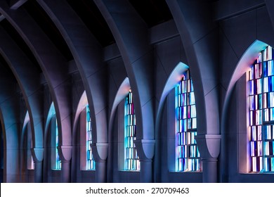 Arched columns in monastery chapel with stained glass windows