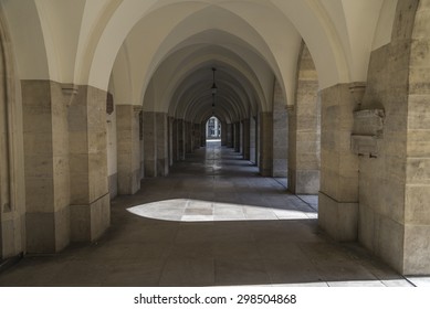 An arched hallway recedes in the distance of a church in Vienna Austria.