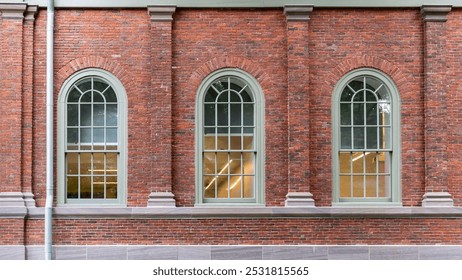 Arched windows on a red brick Harvard University building facade in Cambridge, Massachusetts, USA - Powered by Shutterstock