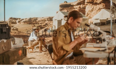 Archeological Digging Site: Two Great Archeologists Work on Excavation Site, Carefully Cleaning with Brushes and Tools Newly Discovered Ancient Civilization Cultural Artifacts, Fossil Remains