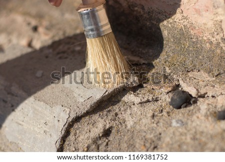 archeology female hand holds a tassel excavation of rare materials treasure hunt and archeology find rare 
resources.
Ideal for archeology news