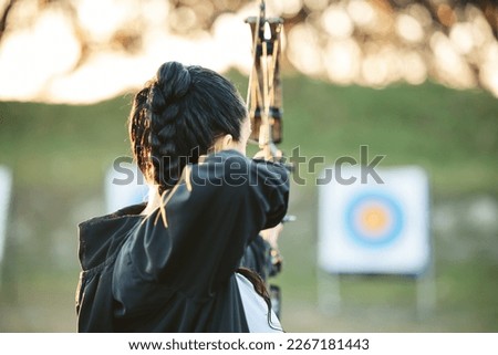 Archer, arrow target training and practice for archery competition, athlete challenge or competitive shooting. Sports field girl, bow hunting and woman focus on precision, aim or back view objective