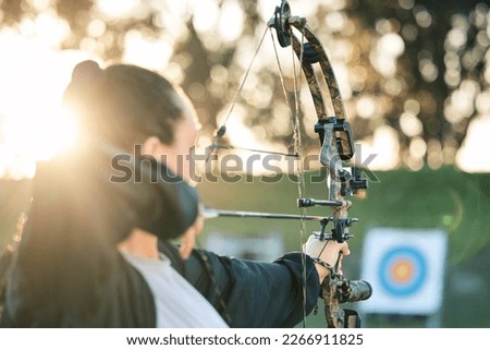 Archer woman, target and bow and arrow practice for outdoor archery, athlete challenge or girl field competition. Shooting goals, talent and competitive focus on precision training, aim or objective