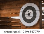 Archery shooting target with arrows on wooden on archery range. Archery range: Wooden target with arrows and bow, perfect for showcasing precision sports