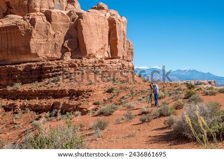 ARCHES NATIONAL PARK, UT - OCTOBER 4, 2014: Photographer in Arches National Park near Moab in Utah. The park contains more than 2000 natural sandstone arches.