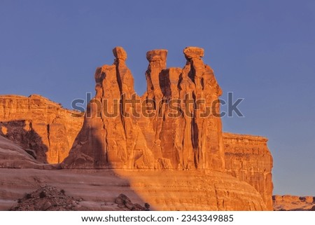 Arches National Park's Courthouse Towers' Three Gossips in the Morning with First Light from Sunrise