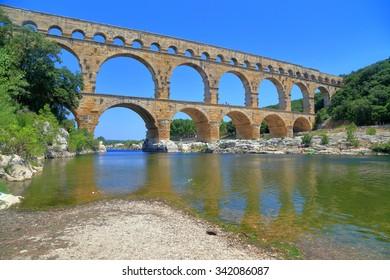 Arches of Pont du Gard across a river near Nimes, France