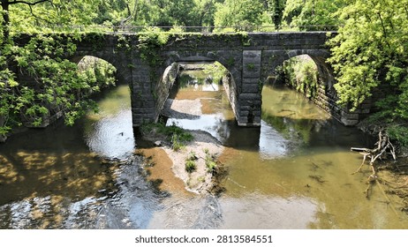 The arches within this structure become the appeal that allows pedestrians to pass across a river channel unhindered.