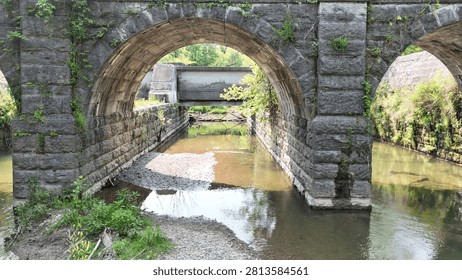 The arches within this structure become the appeal that allows pedestrians to pass across a river channel unhindered.