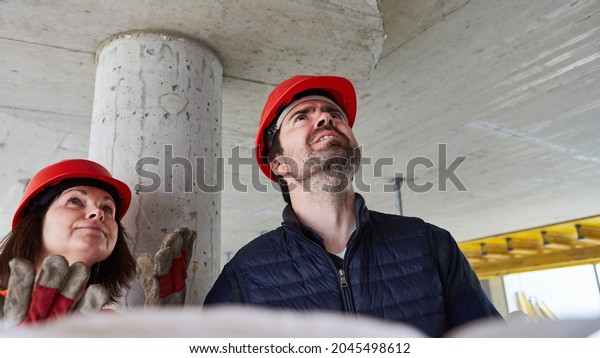 The\
architect and building surveyor find construction defects during an\
inspection on the construction site in the\
shell