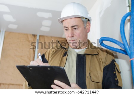 architect checking insulation during house construction