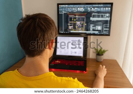 Architect concept: architect on workstation working with autocad drawings