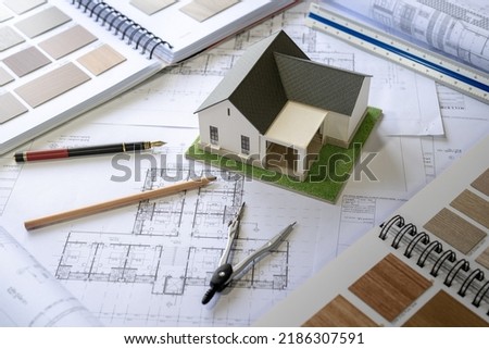 Architect Design Concept, House model on Buleprint construction drawing and drawing equipment stationary