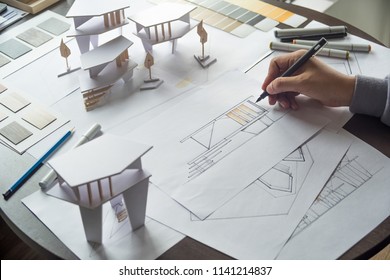 architect design working drawing sketch plans blueprints and making architectural construction model in architect studio - Shutterstock ID 1141214837