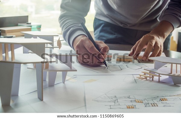 architect design working drawing sketch plans
blueprints and making architectural construction model in architect
studio