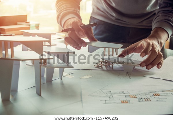 architect design working drawing sketch plans\
blueprints and making architectural construction model in architect\
studio