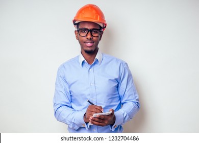 Architect Designer Black Man African American Holding Paper Drawing Template.happy African Builder Painting House,businessman Wears A Helmet Hard Hat.young Guy Is Painting Sketch Construction Plan