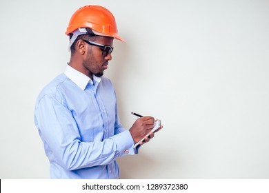 Architect Designer Black Man African American Holding Paper Drawing Template.happy African Builder Painting House,businessman Wears A Helmet Hard Hat.young Guy Is Painting Sketch Construction Plan