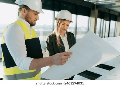 architect, designer, engineer examine the project on paper. A business woman and an architect are talking about a project in an office interior - Powered by Shutterstock