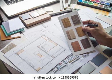 Architect designer Interior creative decoration working hand drawing sketch plan blue print selection material color samples art tools Design Studio - Shutterstock ID 1150869596