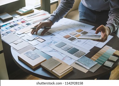Architect designer Interior creative working hand drawing sketch plan blue print selection material color samples art tools Design Studio - Shutterstock ID 1142928158