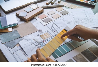 Architect designer Interior creative working hand drawing sketch plan blueprint selection material color samples art tools Design Studio - Shutterstock ID 1167256204