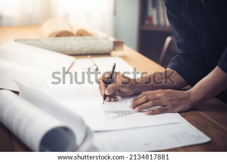 Architect designer Interior creative working hand drawing sketch plan blue print selection material color samples art tools Design Studio. Cropped image of the building plan. fake blueprint for stock.