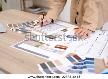 Architect designer Interior creative working drawing sketch plan  selection material color samples art tools Design Studio.Photo concept of work on technical drawings.material sample on creative desk