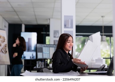 Architect Discussing Building 3d Printed Model On Videocall In Architecture Office. Asian Employee Talking About Cad Design On Videoconference, Engineer Online Presentation, 3d Blueprint.