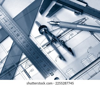 architect drafting tools displayed over detail blueprint