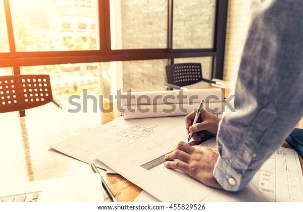 architect
drawing architectural project on blueprint, engineering concept,
architecture concept, soft focus, vintage
tone