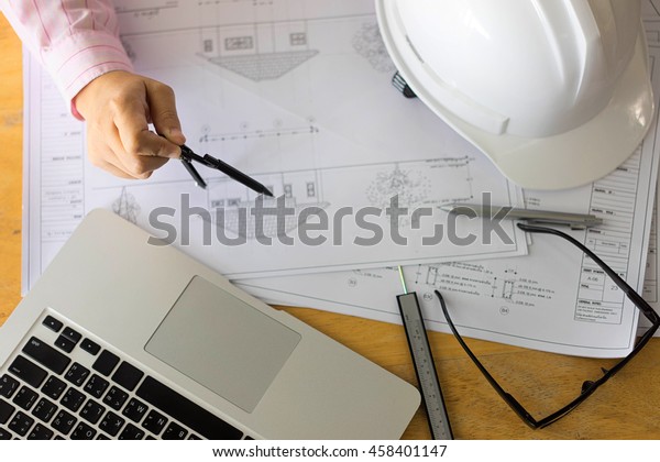 architect\
drawing architectural project on blueprint, engineering concept,\
architecture concept, soft focus, vintage\
tone